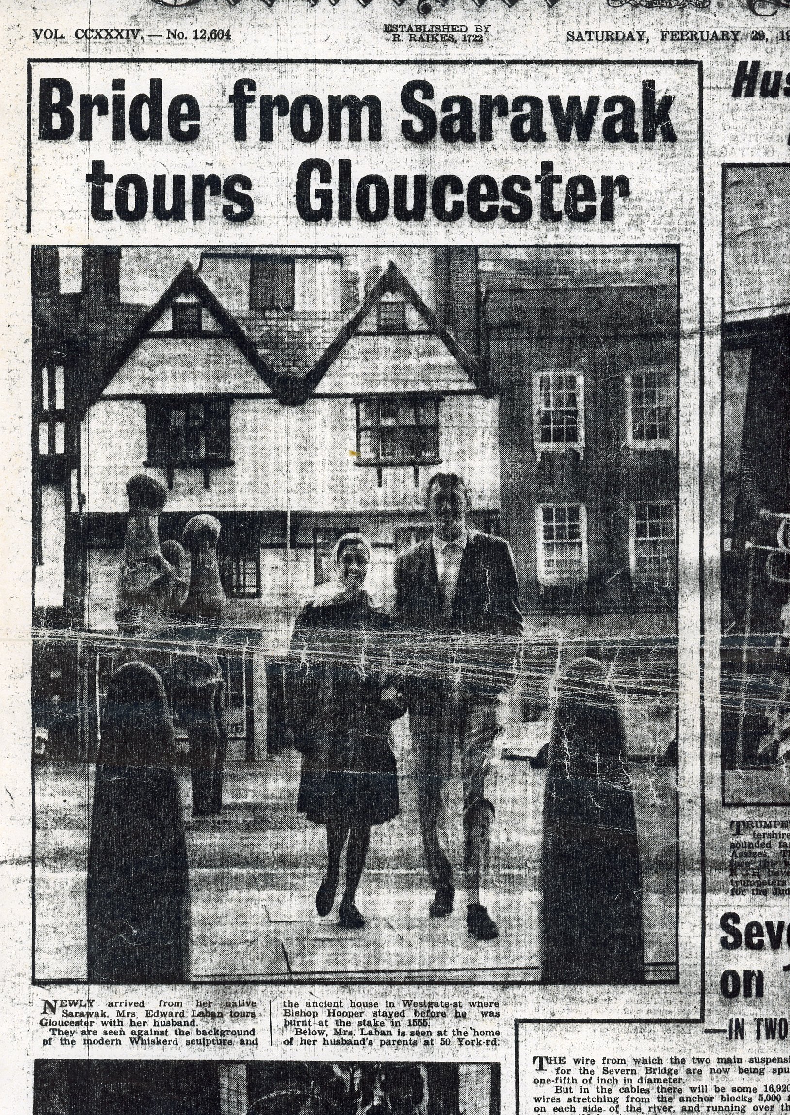 A newspaper cutting from The Citizen Newspaper of Alice and her husband standing next to the family statue when she first moved to Gloucester from Sarawak.