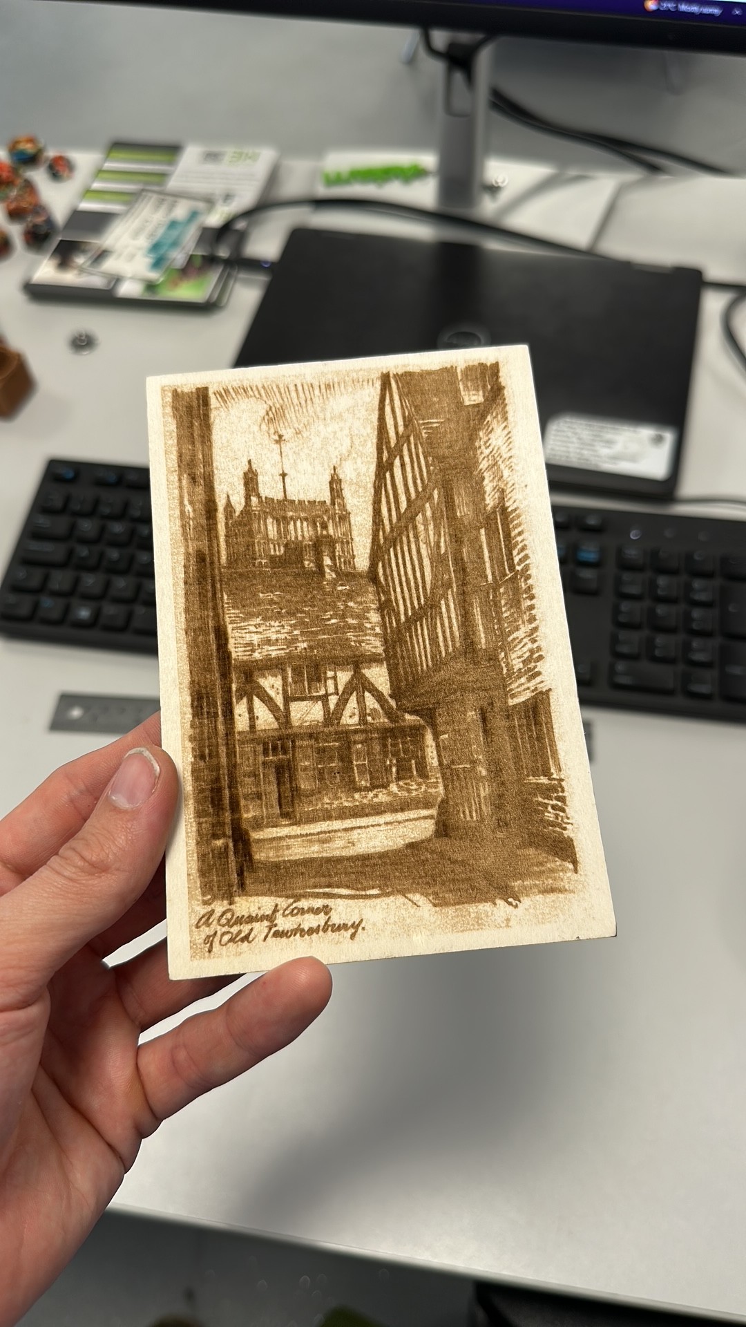 A laser cut postcard made of plywood, with an image of Tewkesbury Abbey.