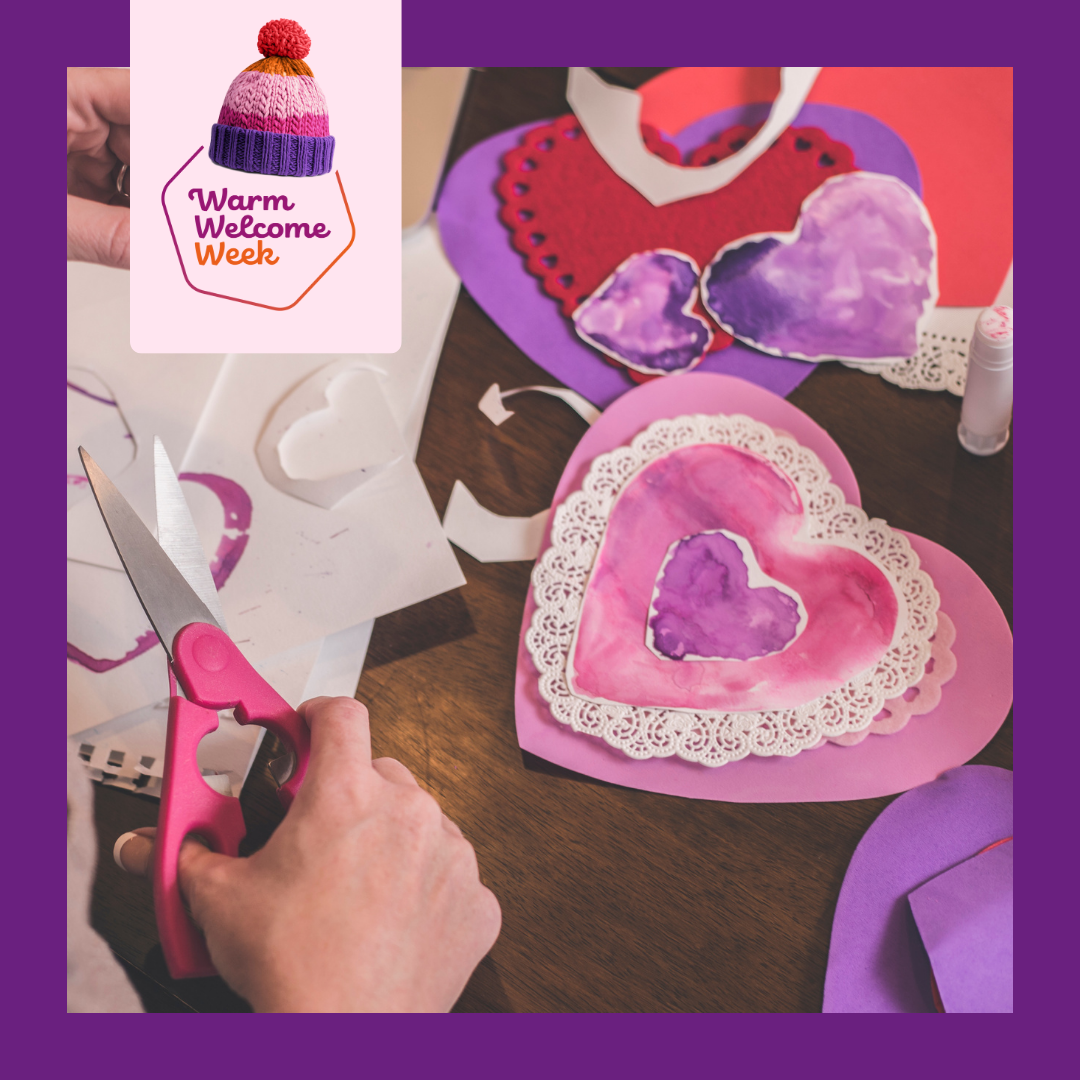 Image of paper heart decorations and someone crafting