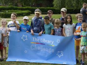 Children holding The Library Challenge banner