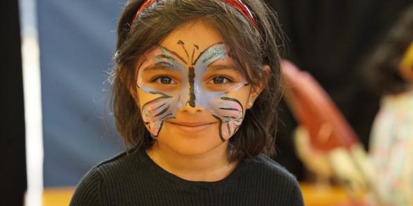 Child with face paint at family festival