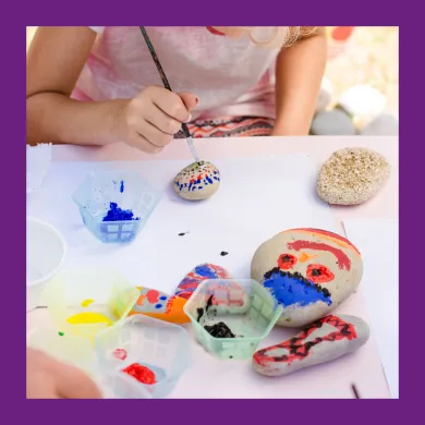 child painting stones