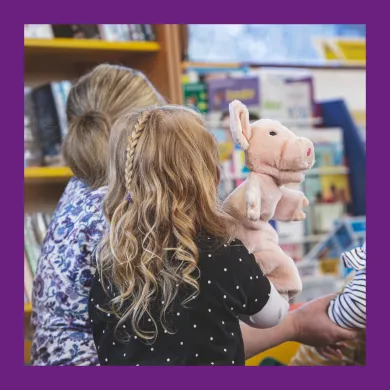 image of the back of a child's head, holding a toy