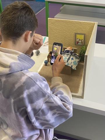 young person taking pictures for stop motion workshop