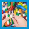 An image of a child's hands playing with Lego bricks 
