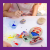 child painting stones